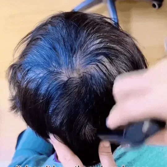 Hair colour stick being applied with a comb